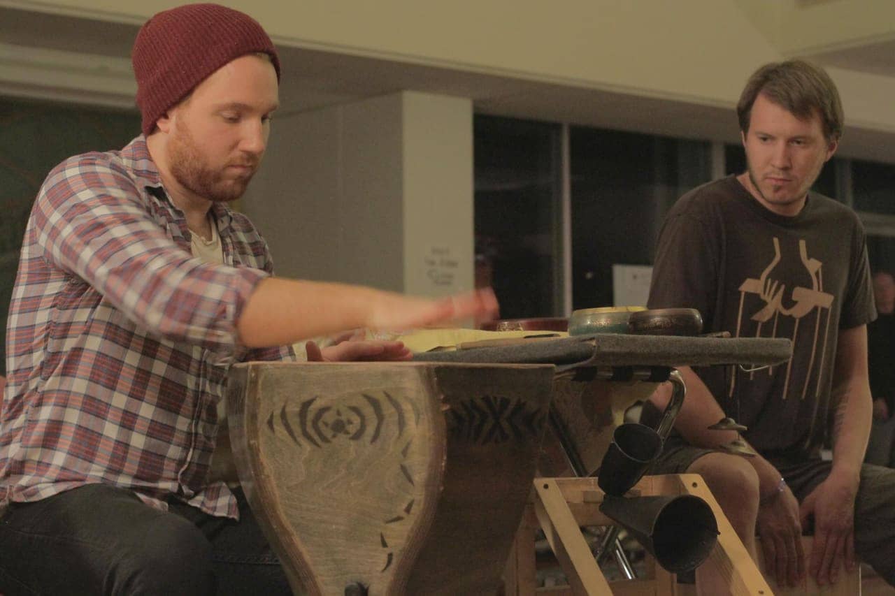 Playing carved wooden drum
